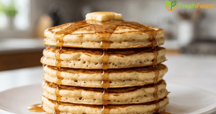 Easy fluffy homemade pancakes stacked on a white plate with melting butter and maple syrup, perfect for a quick breakfast.